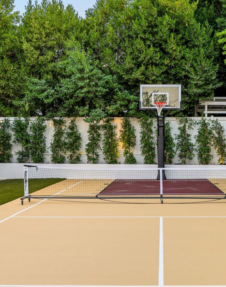 Basketball and Pickleball Court in Backyard with Green Trees in Background