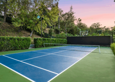 Private Pickleball Court with Green Trees and Garden Surrounding at Sunset