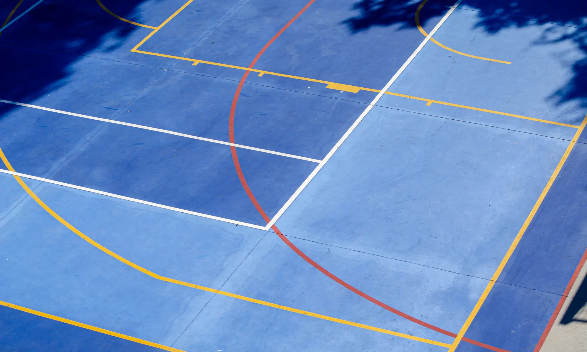 Blue Basketball Court in a School Playground Area